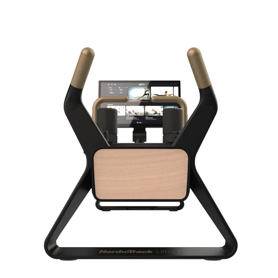 Front view of a NordicTrack Ultra i fitness machine with a large touchscreen display, tan handles, and a light wood panel in the center.